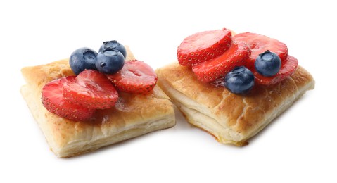 Photo of Tasty puff pastries with berries isolated on white