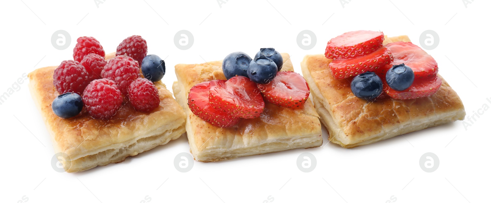 Photo of Tasty puff pastries with berries isolated on white