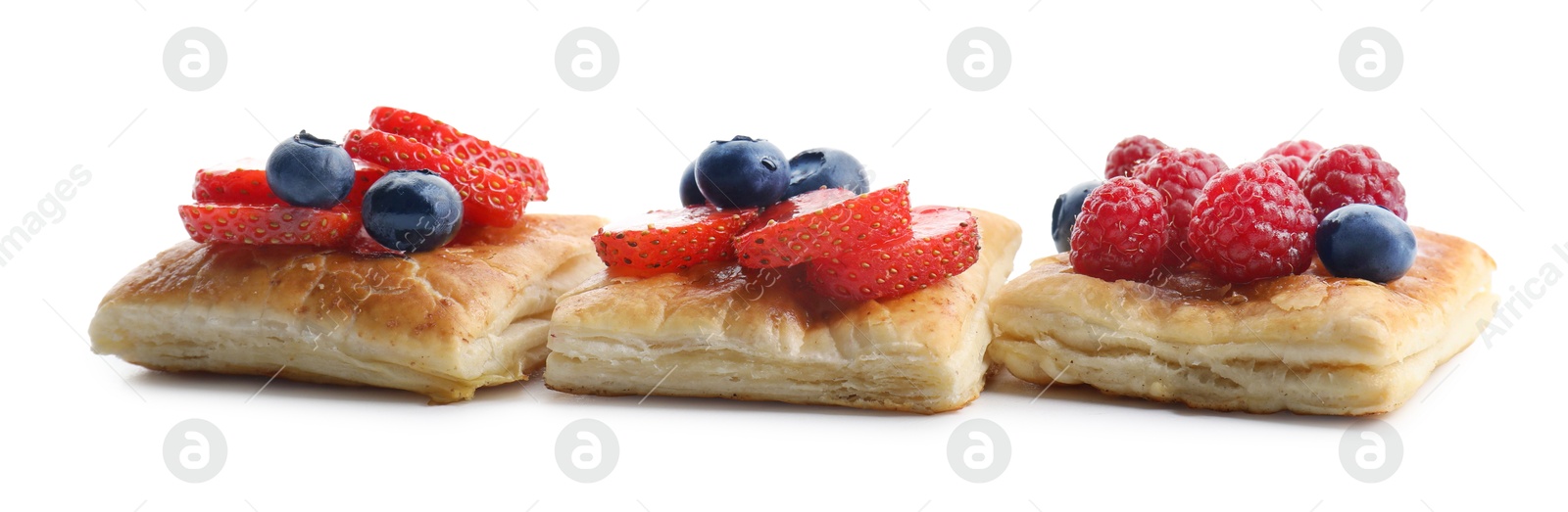 Photo of Tasty puff pastries with berries isolated on white