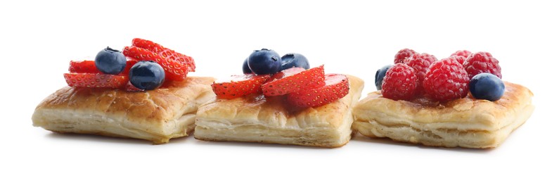 Tasty puff pastries with berries isolated on white