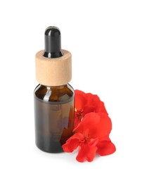 Photo of Bottle of geranium essential oil and beautiful flowers isolated on white