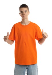 Photo of Teenage boy wearing orange t-shirt and showing thumbs up on white background