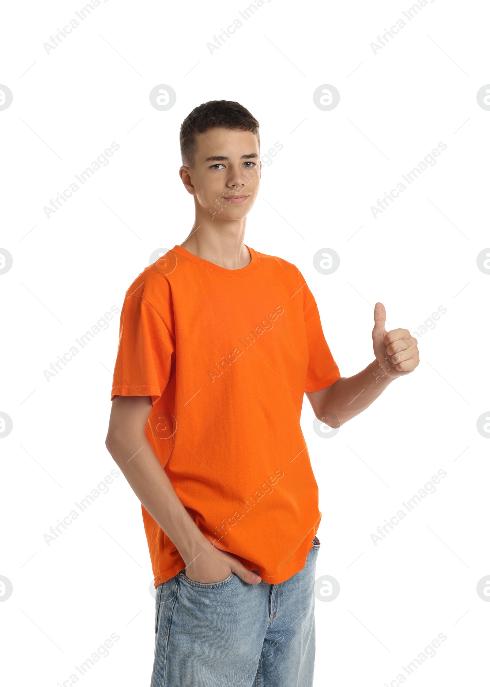 Photo of Teenage boy wearing orange t-shirt and showing thumbs up on white background