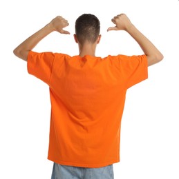 Teenage boy wearing orange t-shirt on white background, back view