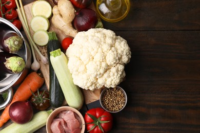 Photo of Different ingredients for stew on wooden table, top view. Space for text