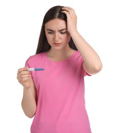 Photo of Confused woman holding pregnancy test on white background