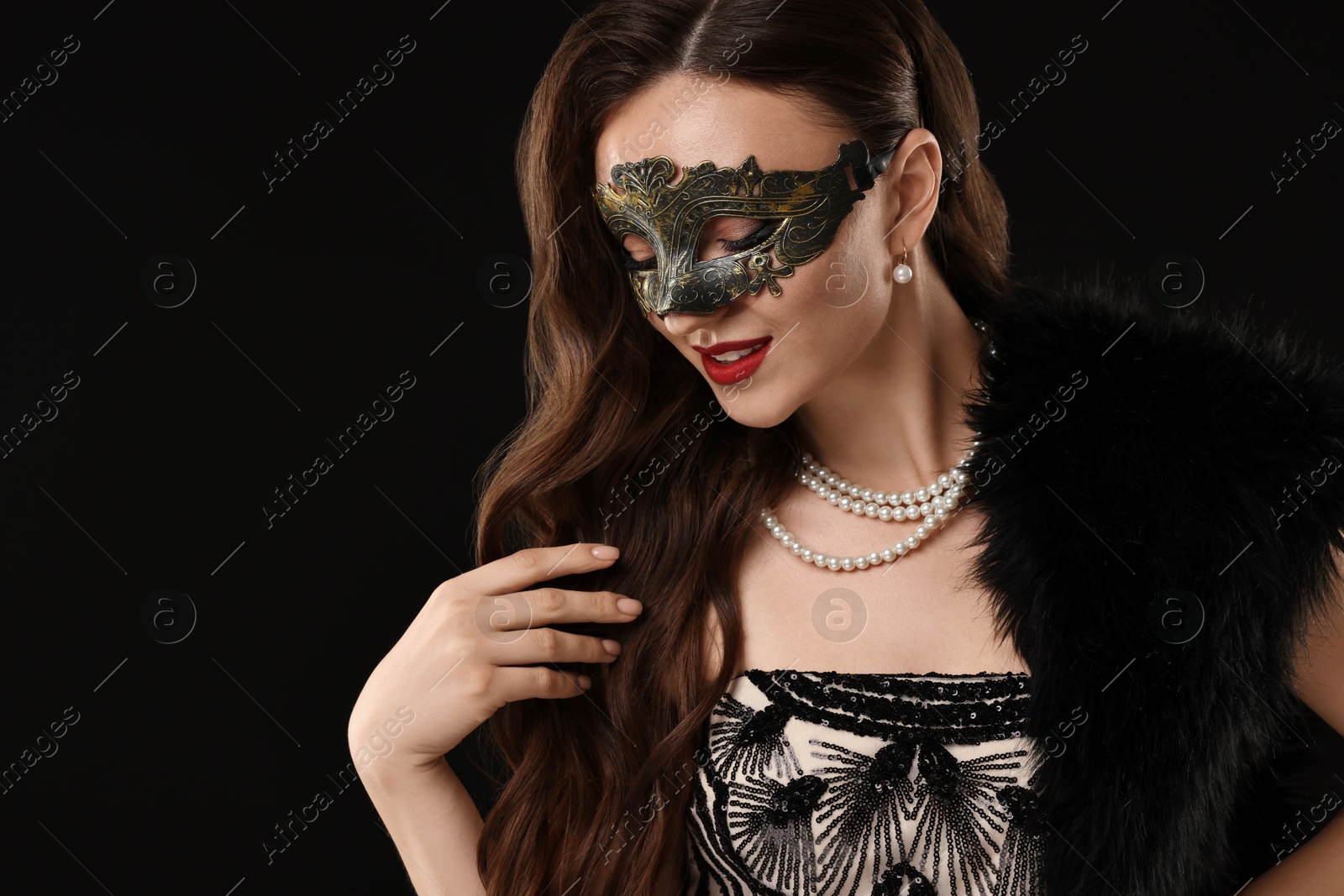 Photo of Beautiful woman wearing carnival mask on black background. Space for text