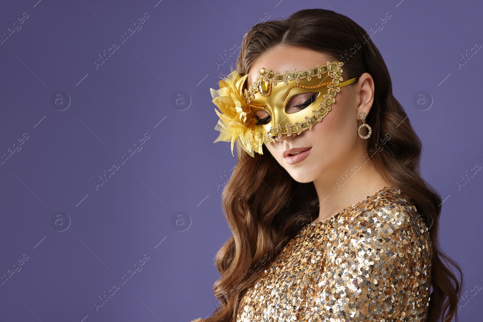 Photo of Beautiful woman wearing carnival mask on purple background. Space for text