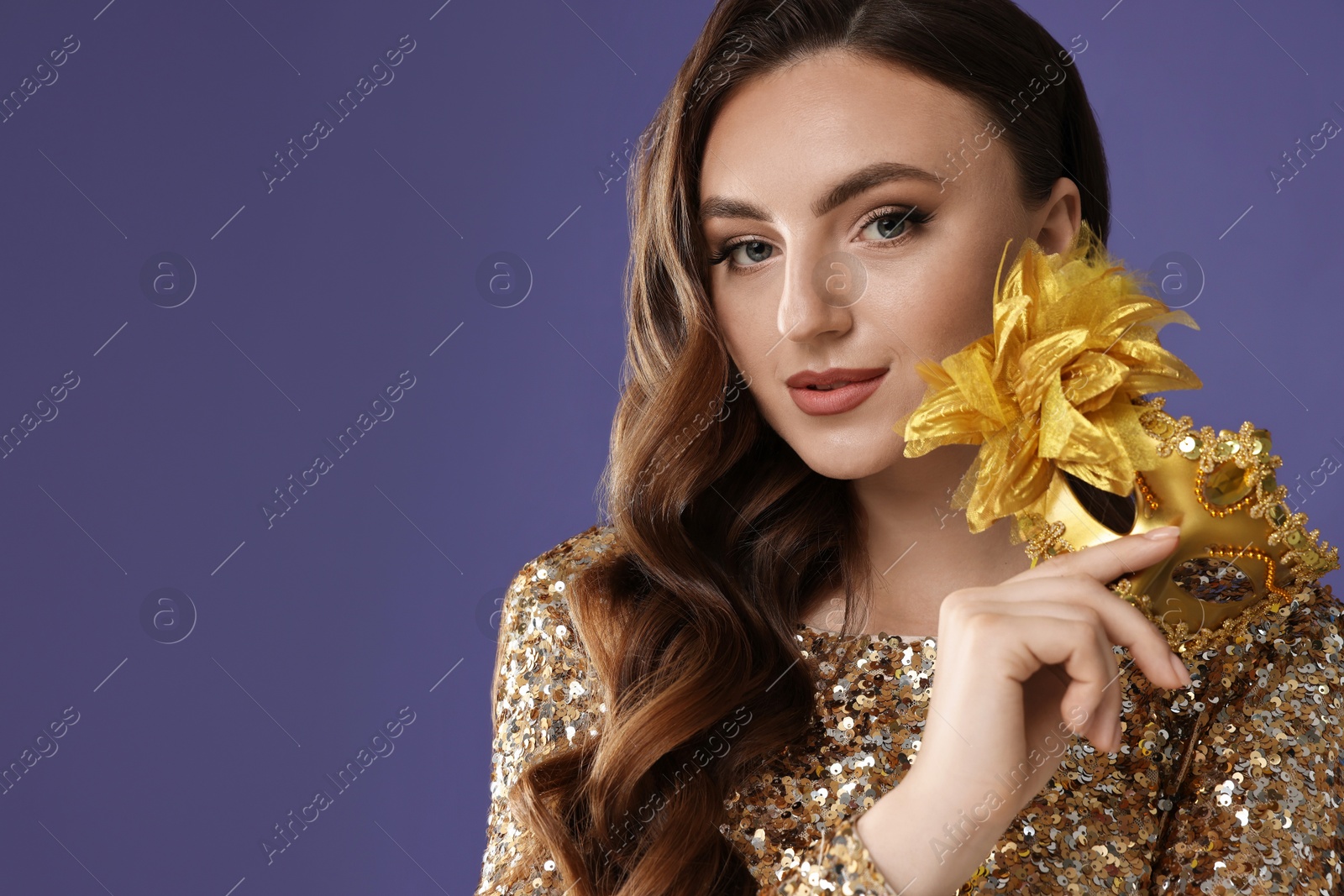 Photo of Beautiful woman with carnival mask on purple background. Space for text