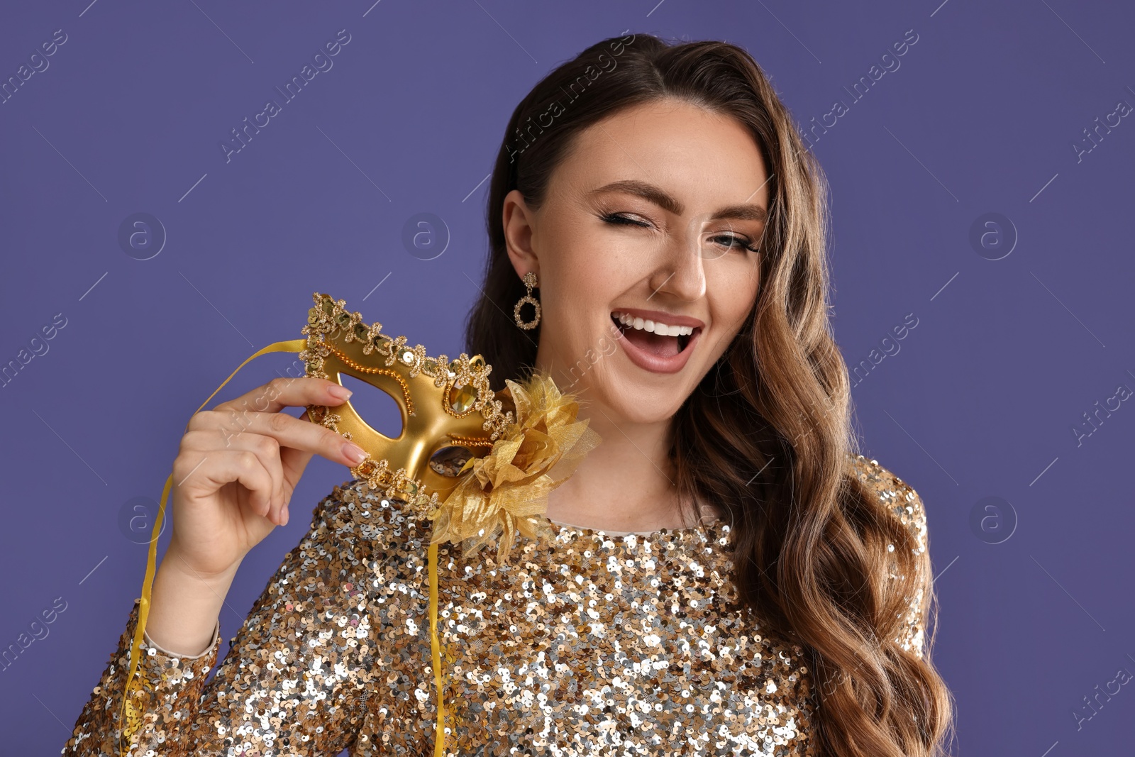 Photo of Happy woman with carnival mask on purple background