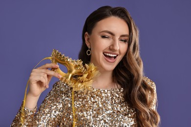 Photo of Happy woman with carnival mask on purple background