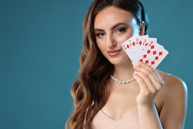 Poker game. Charming woman with playing cards on light blue background. Space for text