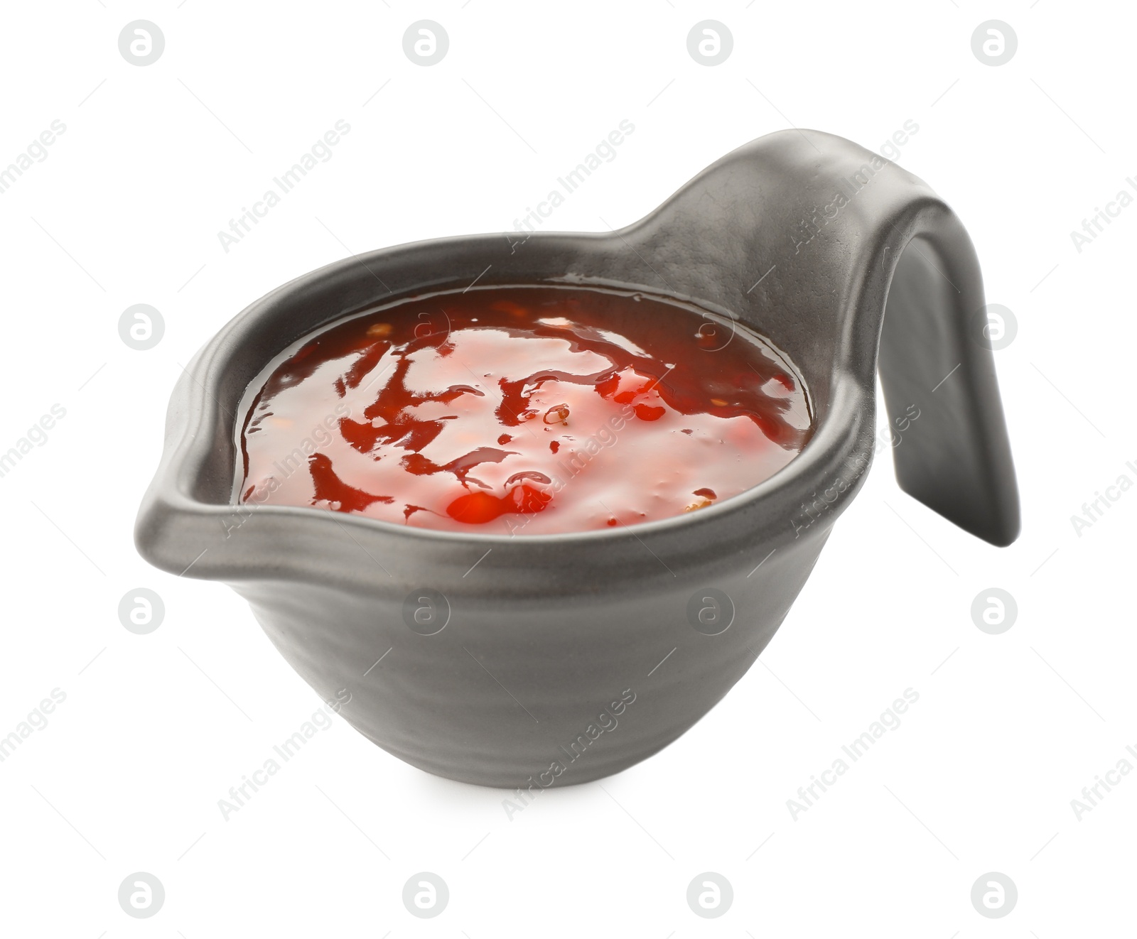 Photo of Hot chili sauce in gravy boat isolated on white