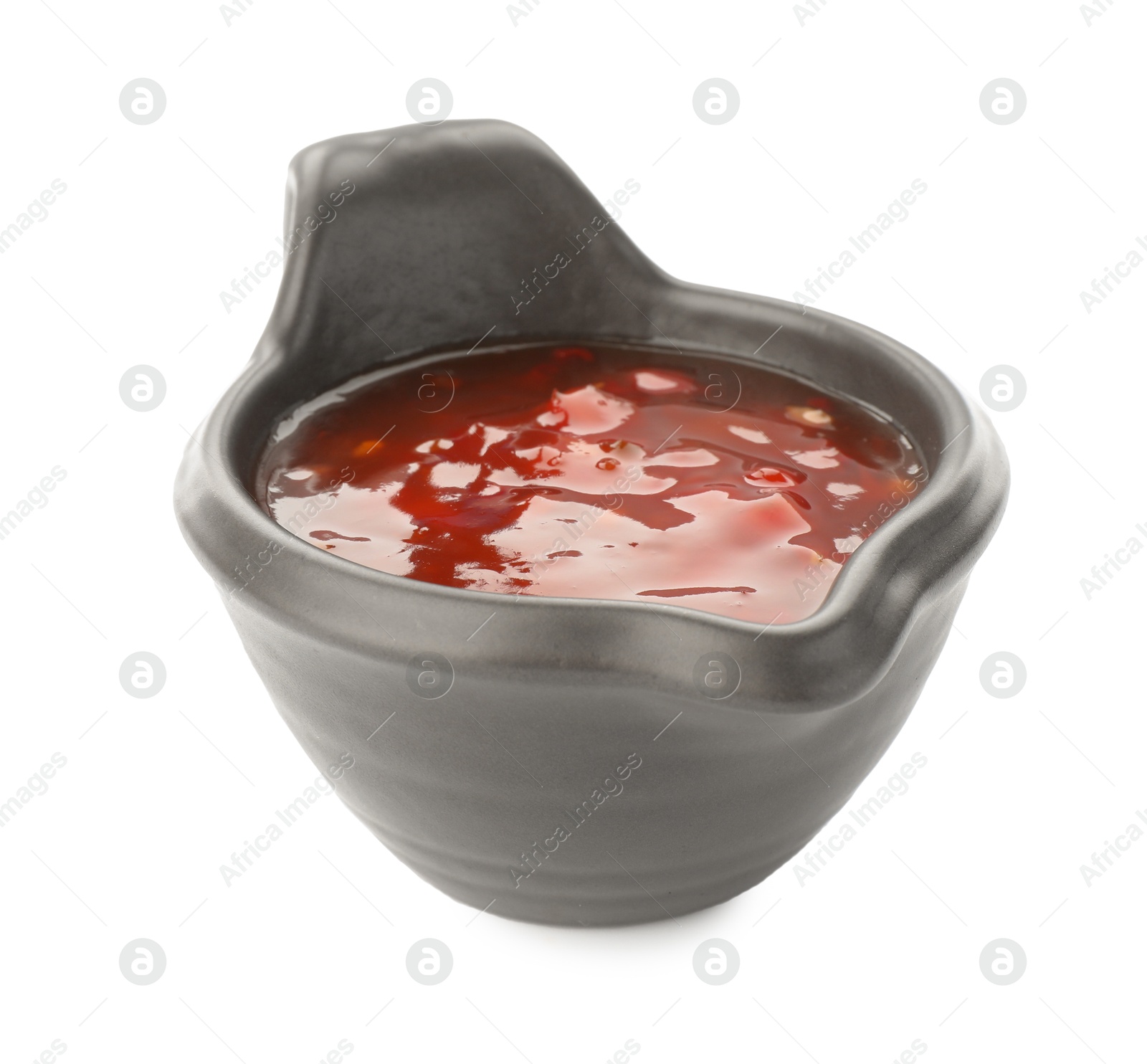 Photo of Hot chili sauce in gravy boat isolated on white