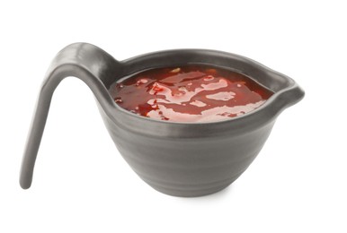 Photo of Hot chili sauce in gravy boat isolated on white