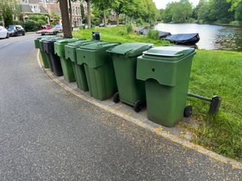 Many green trash bins on city street