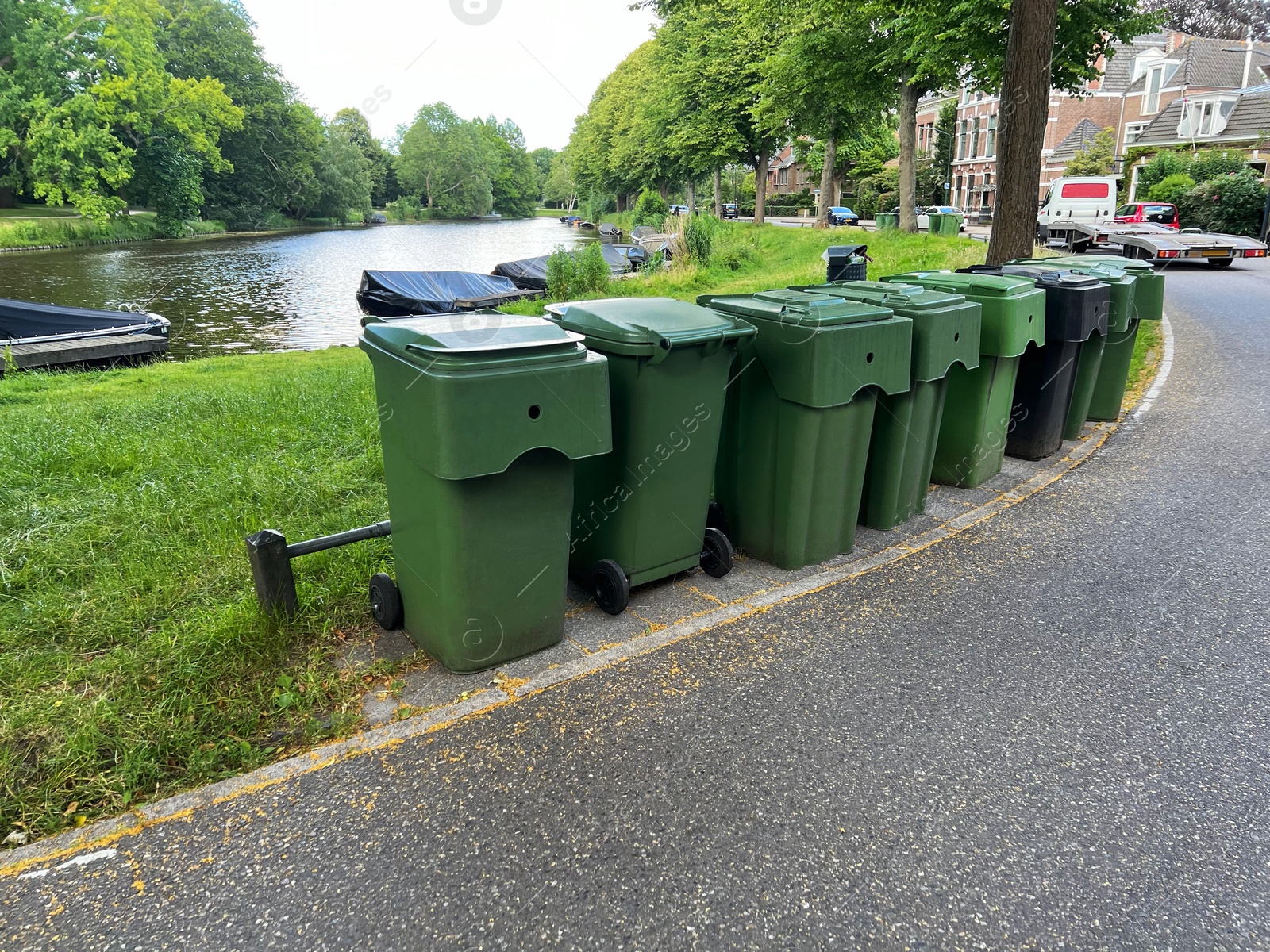 Photo of Many green trash bins on city street