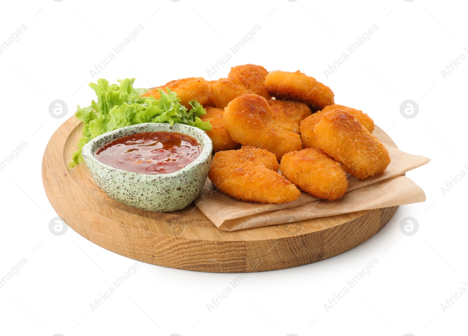 Photo of Board with hot chili sauce, lettuce and nuggets isolated on white