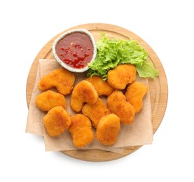 Photo of Board with hot chili sauce, lettuce and nuggets isolated on white, top view