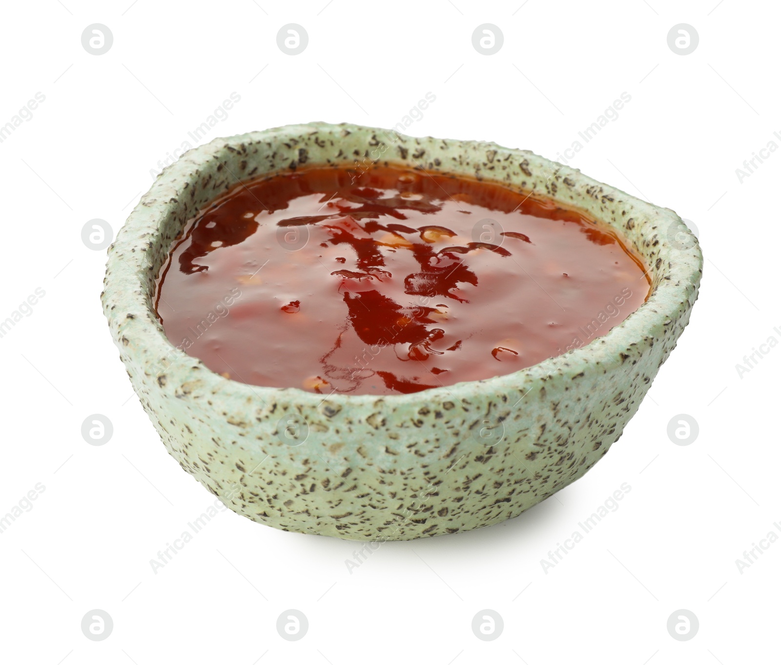 Photo of Hot chili sauce in bowl isolated on white