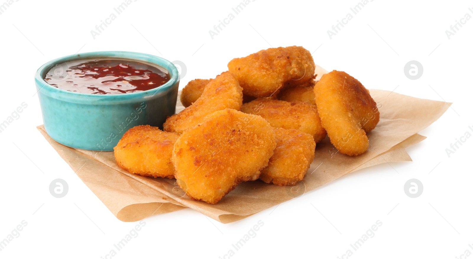 Photo of Hot chili sauce and pile of nuggets isolated on white