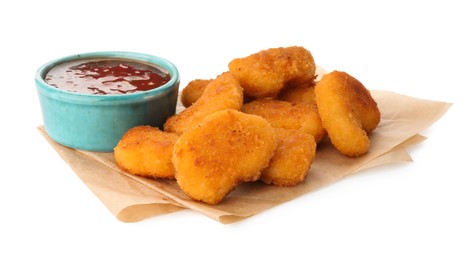 Photo of Hot chili sauce and pile of nuggets isolated on white