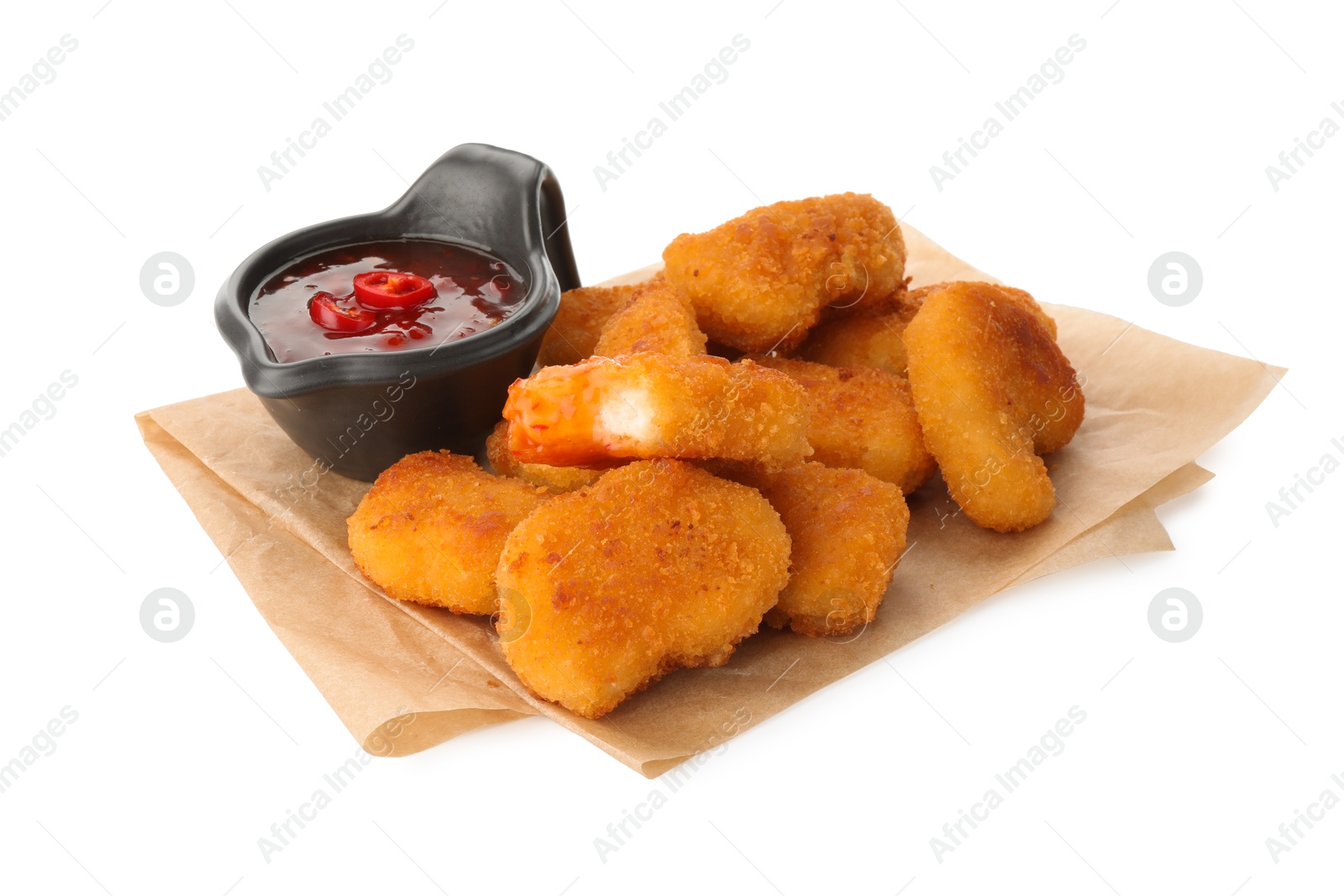 Photo of Hot chili sauce and pile of nuggets isolated on white