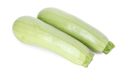 Photo of Two fresh ripe zucchinis isolated on white, top view