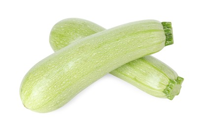 Photo of Two fresh ripe zucchinis isolated on white, above view