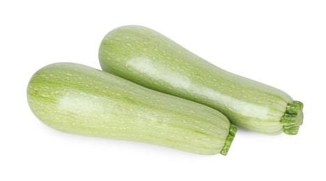 Photo of Two fresh ripe zucchinis isolated on white, top view