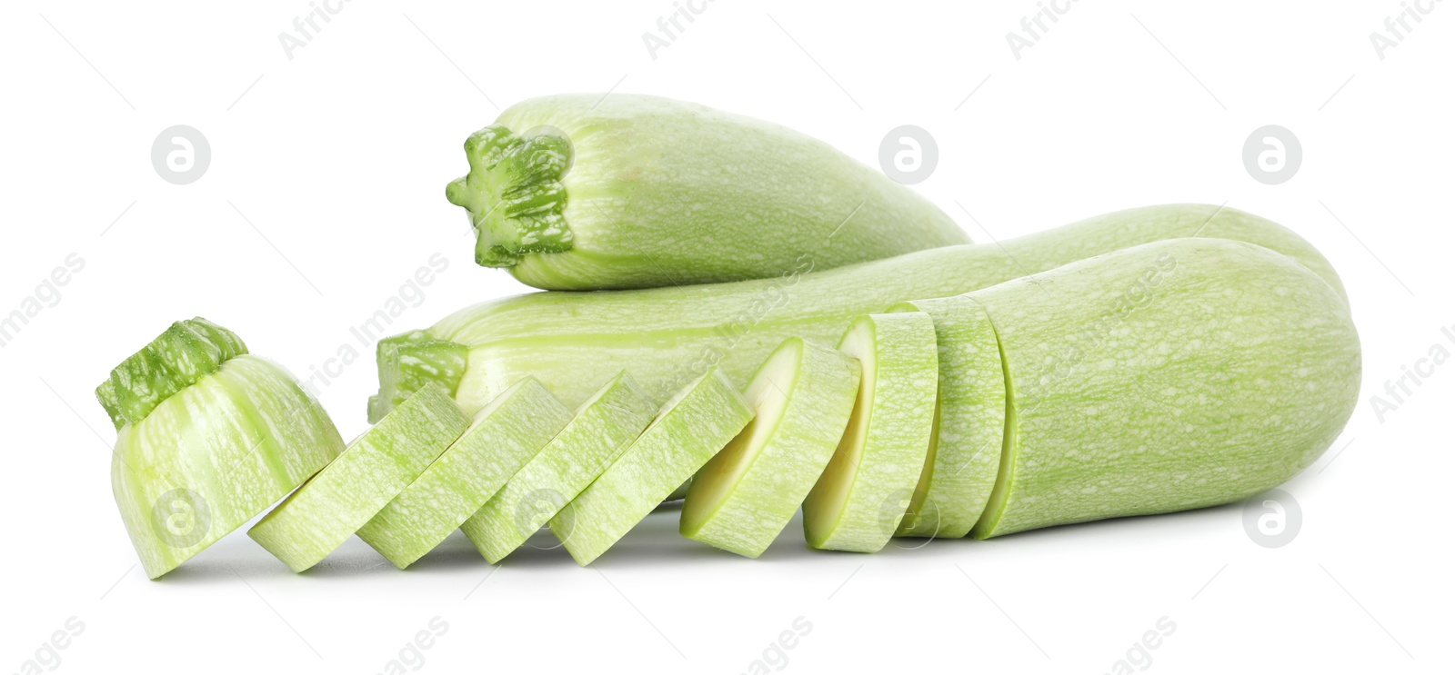 Photo of Fresh whole and cut zucchinis isolated on white