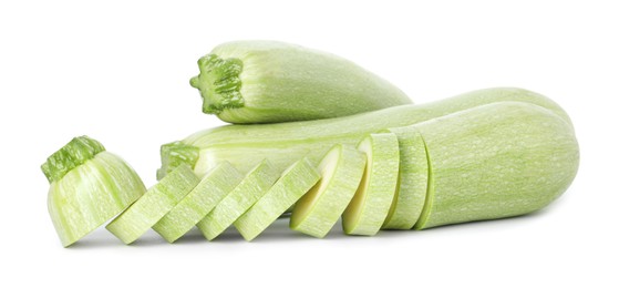 Photo of Fresh whole and cut zucchinis isolated on white