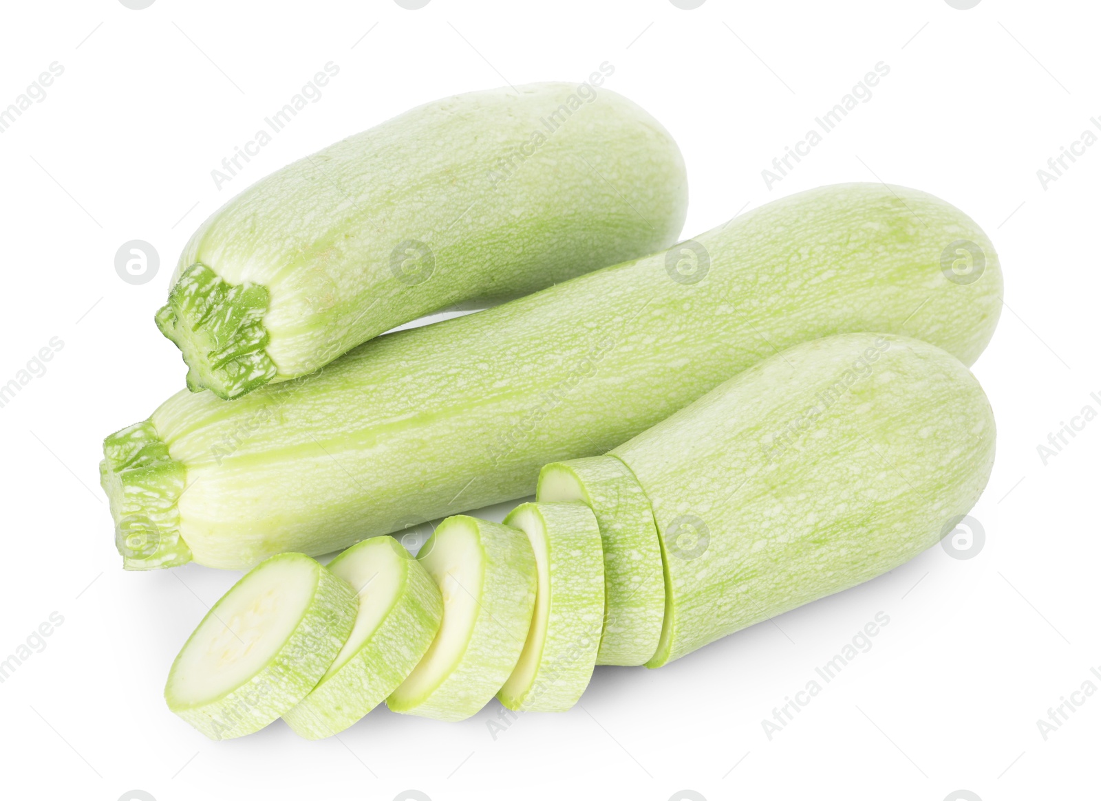 Photo of Fresh whole and cut zucchinis isolated on white, above view