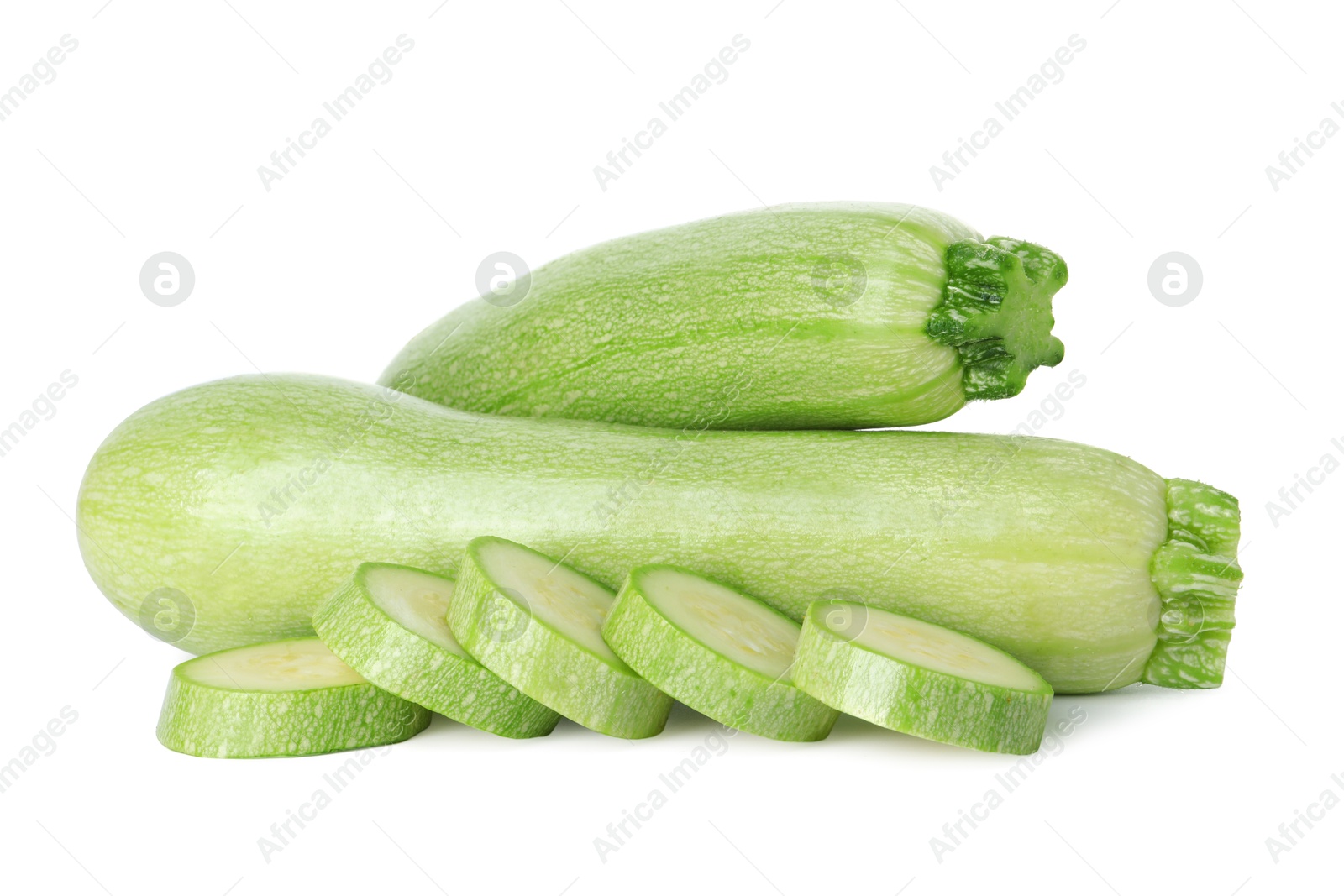 Photo of Fresh whole and cut zucchinis isolated on white