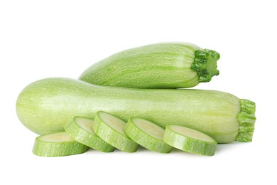 Photo of Fresh whole and cut zucchinis isolated on white