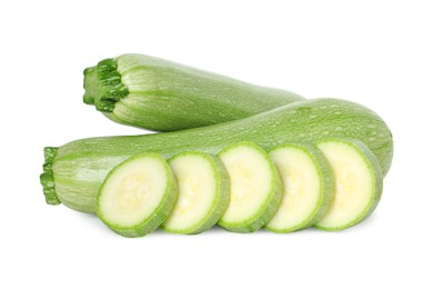 Photo of Fresh whole and cut zucchinis isolated on white