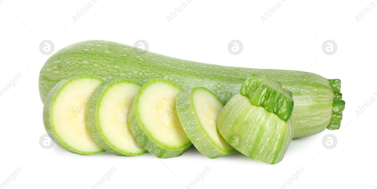 Photo of Fresh whole and cut zucchinis isolated on white