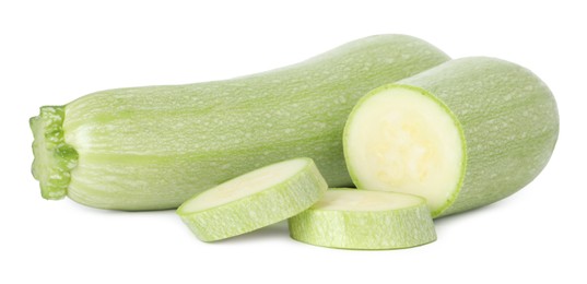 Photo of Fresh whole and cut zucchinis isolated on white