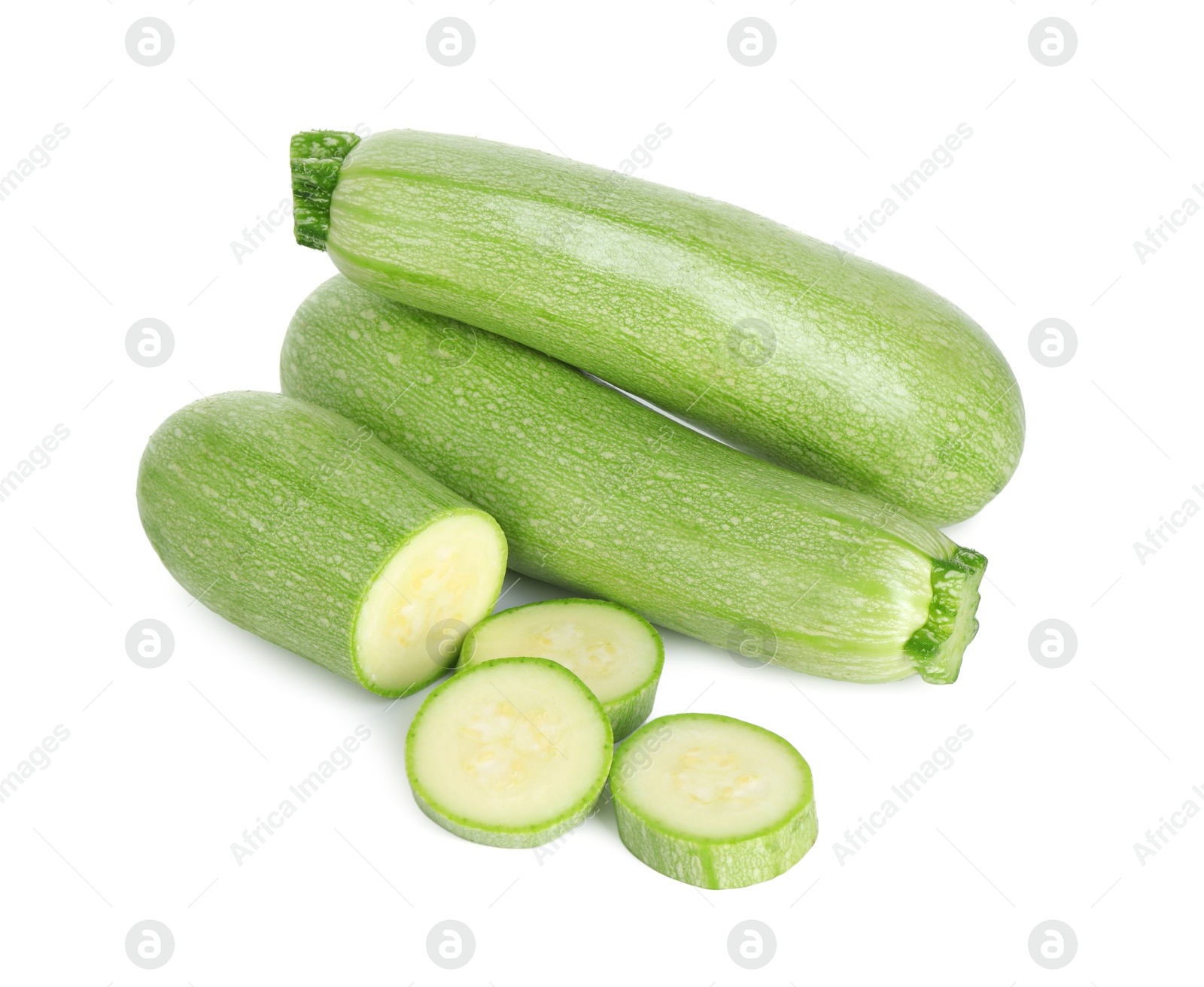 Photo of Fresh whole and cut zucchinis isolated on white