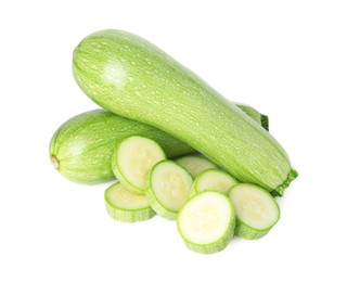 Photo of Fresh whole and cut zucchinis isolated on white, above view