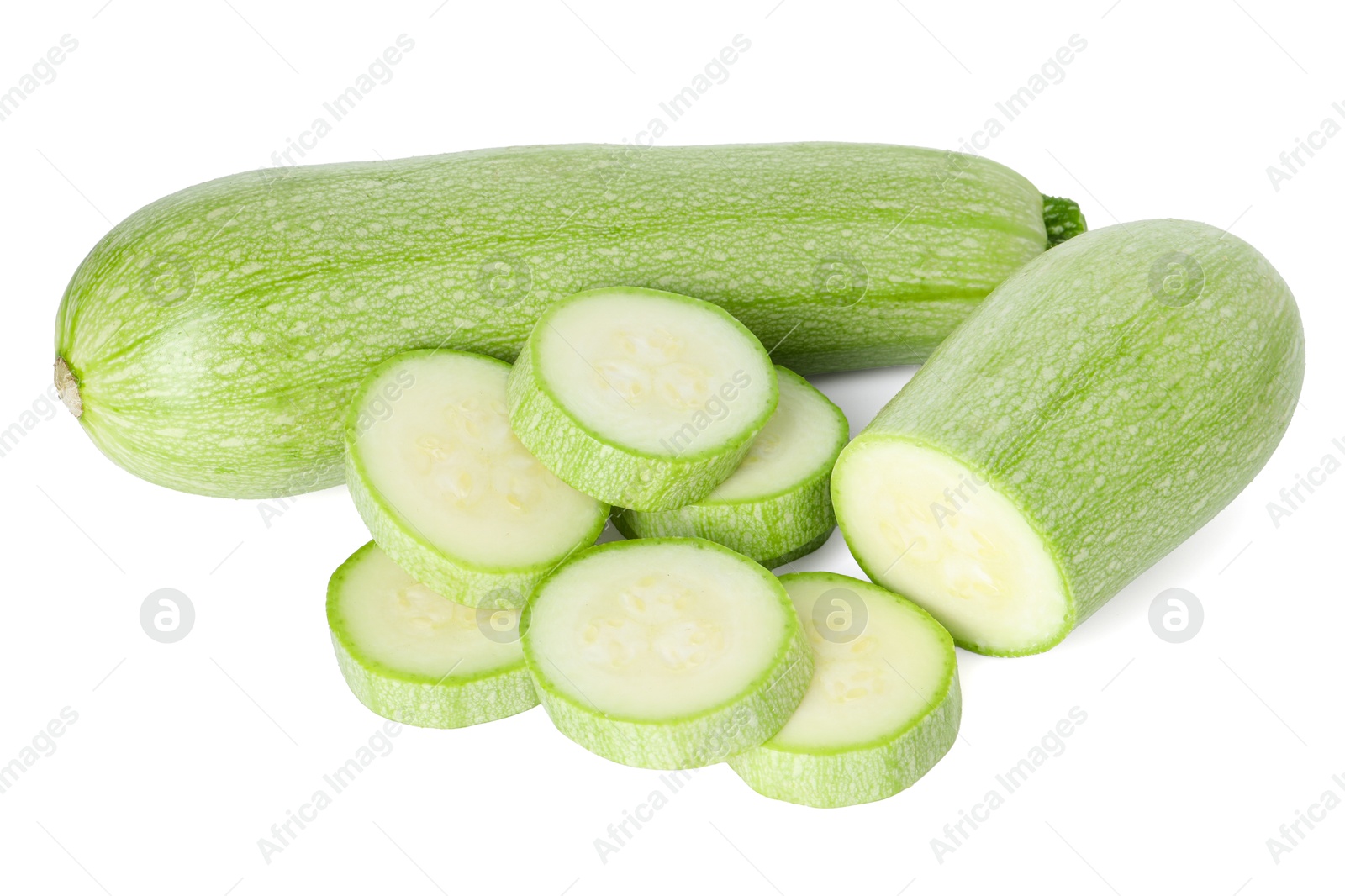 Photo of Fresh whole and cut zucchinis isolated on white