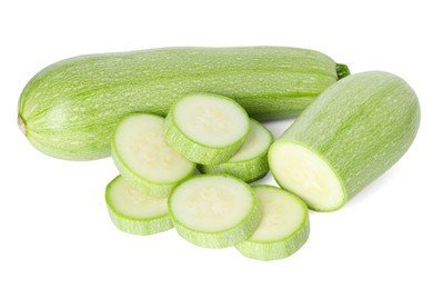 Photo of Fresh whole and cut zucchinis isolated on white