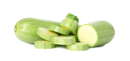 Photo of Fresh whole and cut zucchinis isolated on white