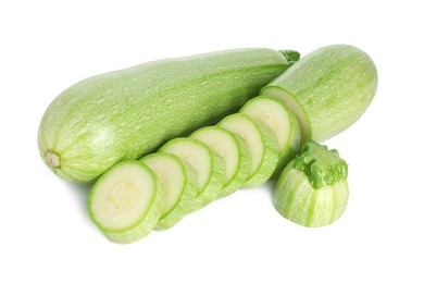 Photo of Fresh whole and cut zucchinis isolated on white