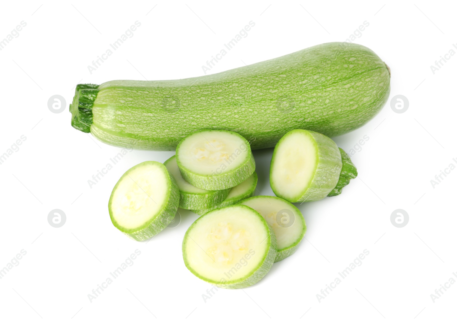 Photo of Fresh whole and cut zucchinis isolated on white, above view