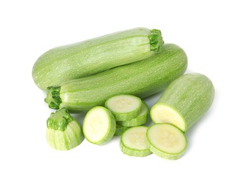 Photo of Fresh whole and cut zucchinis isolated on white