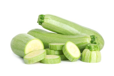 Photo of Fresh whole and cut zucchinis isolated on white