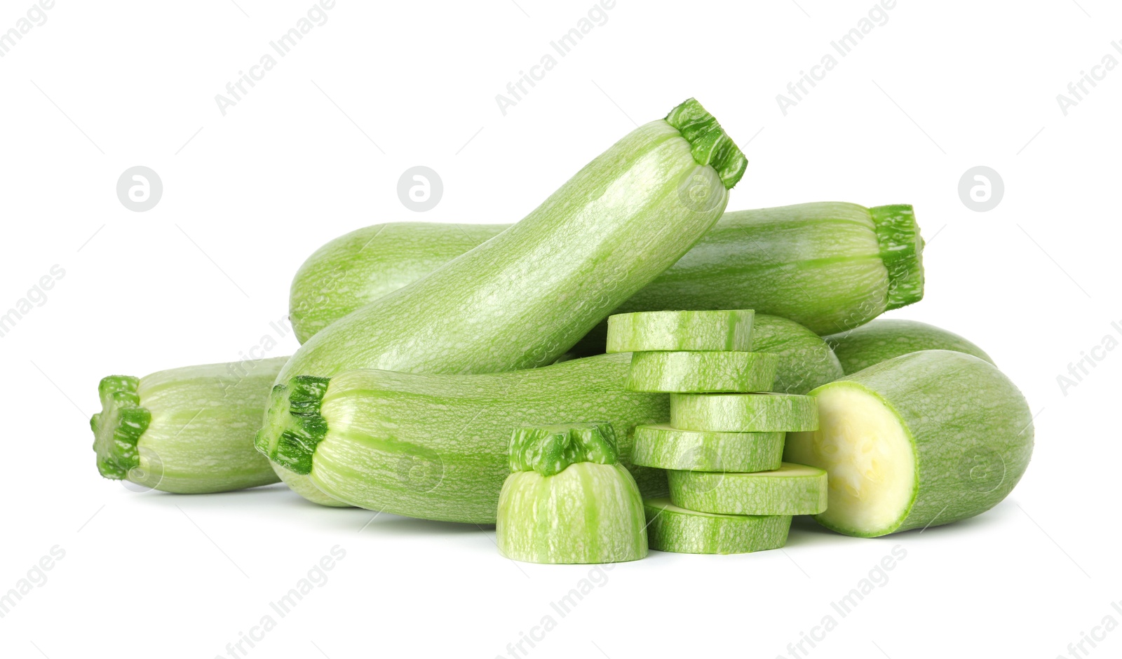 Photo of Fresh whole and cut zucchinis isolated on white