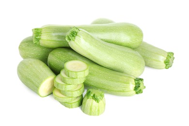 Photo of Fresh whole and cut zucchinis isolated on white