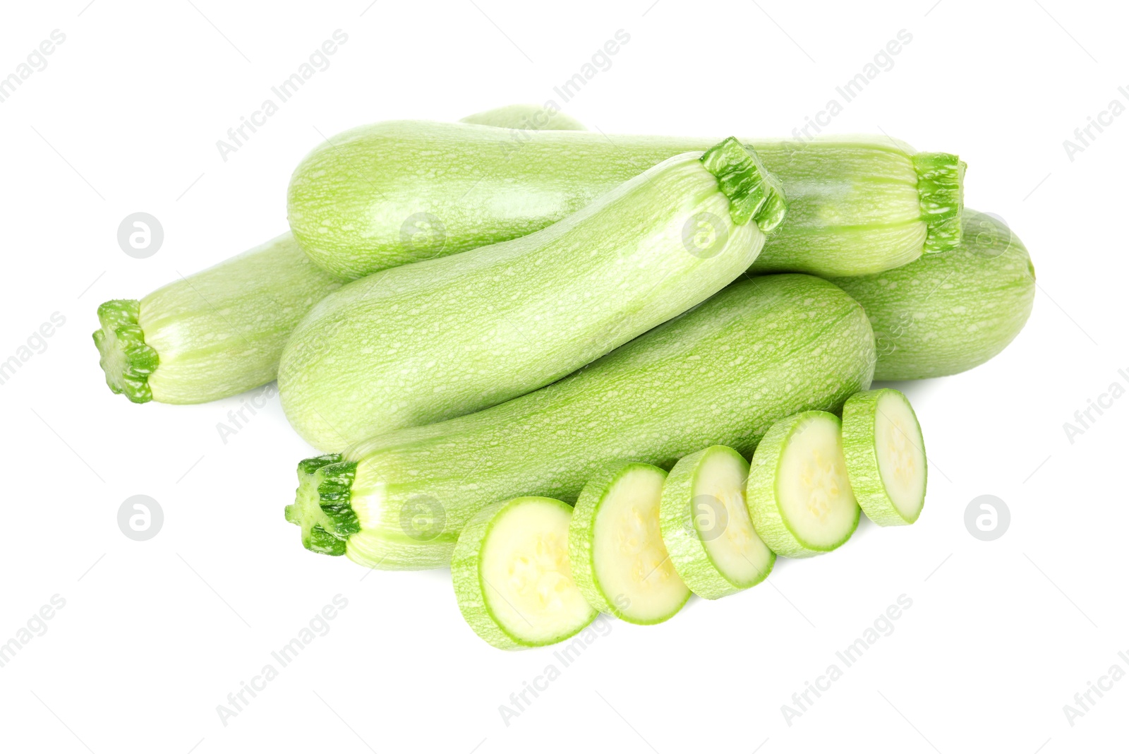 Photo of Fresh whole and cut zucchinis isolated on white, above view